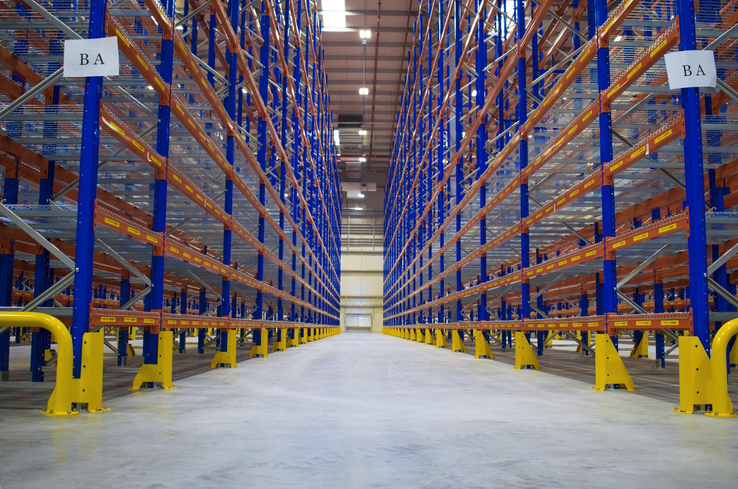 a large warehouse with blue frames and orange beams
