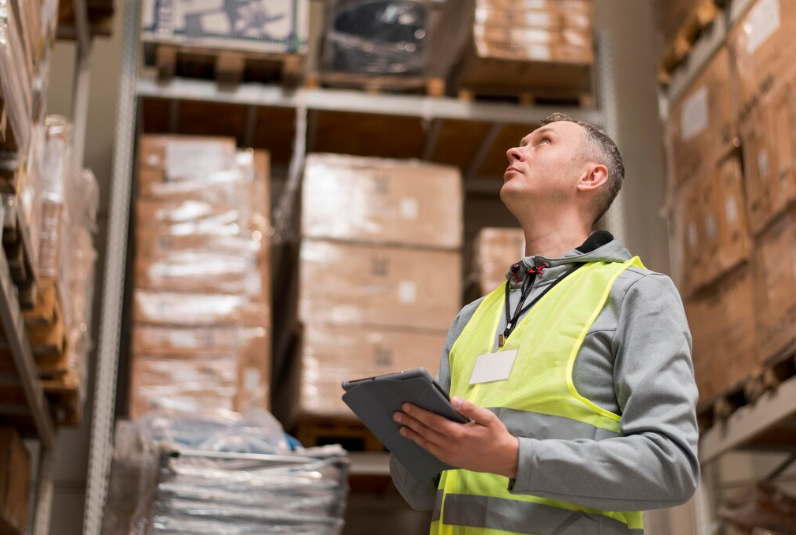 Logistics Manager Inspecting Goods on High Racking Levels