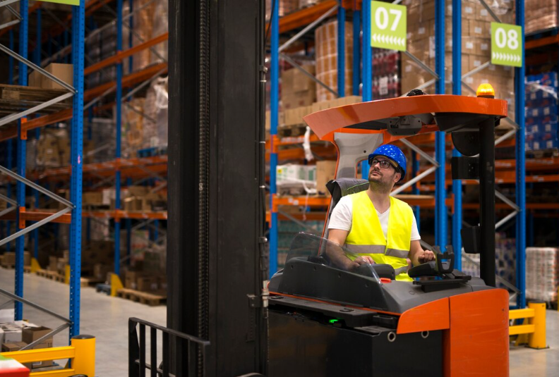 Modern Logistics: drive-in pallet rack is stacking in a Distribution Center